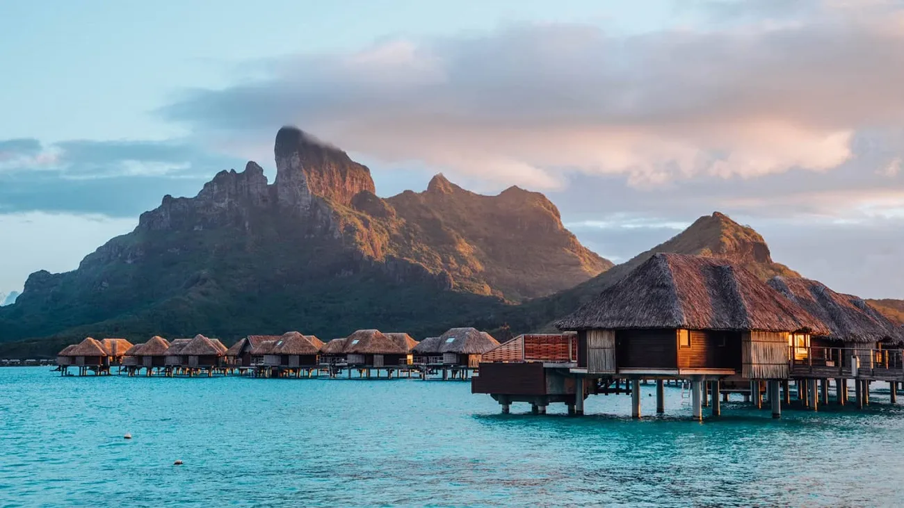 Overwater bungalows in Bora Bora's turquoise lagoon – featured in the 10 Most Expensive Travel Destinations list.