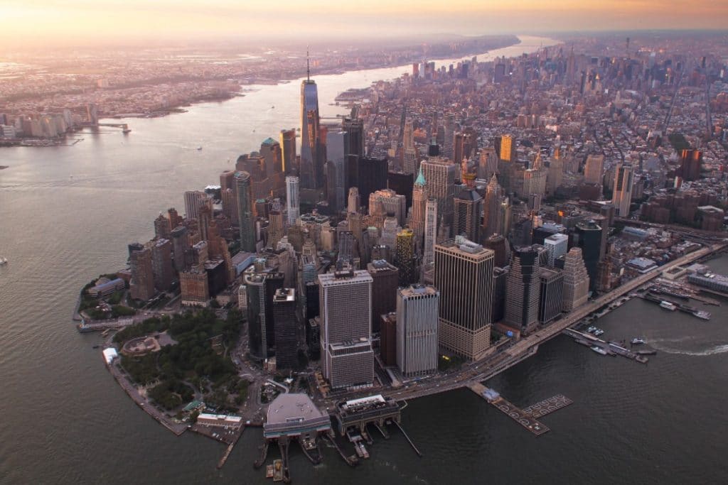 10 Top Cities in the World - New York City skyline featuring the One World Trade Center and vibrant city life.