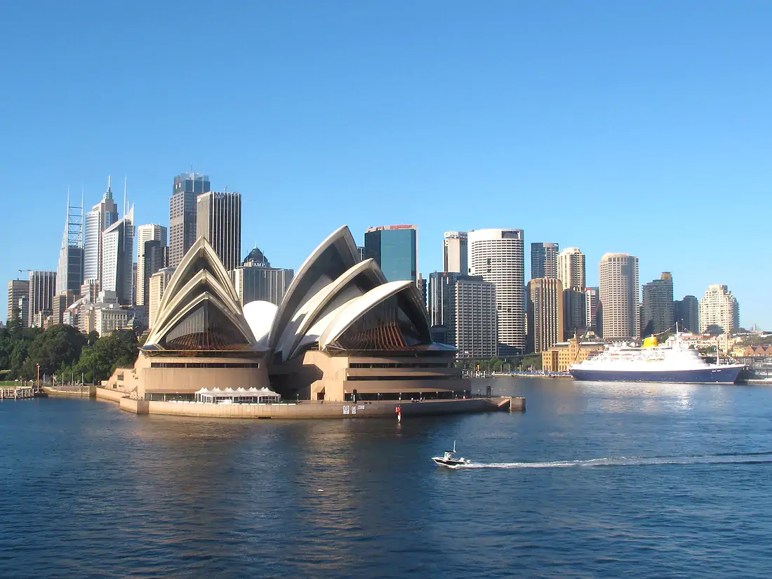 10 Top Cities in the World - Sydney Opera House and cruise liner against a backdrop of the harbour.
