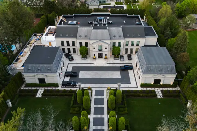 Drake’s “The Embassy” in Toronto from the 10 Most Famous Celebrity Homes, featuring an NBA-size court and piano lounge.