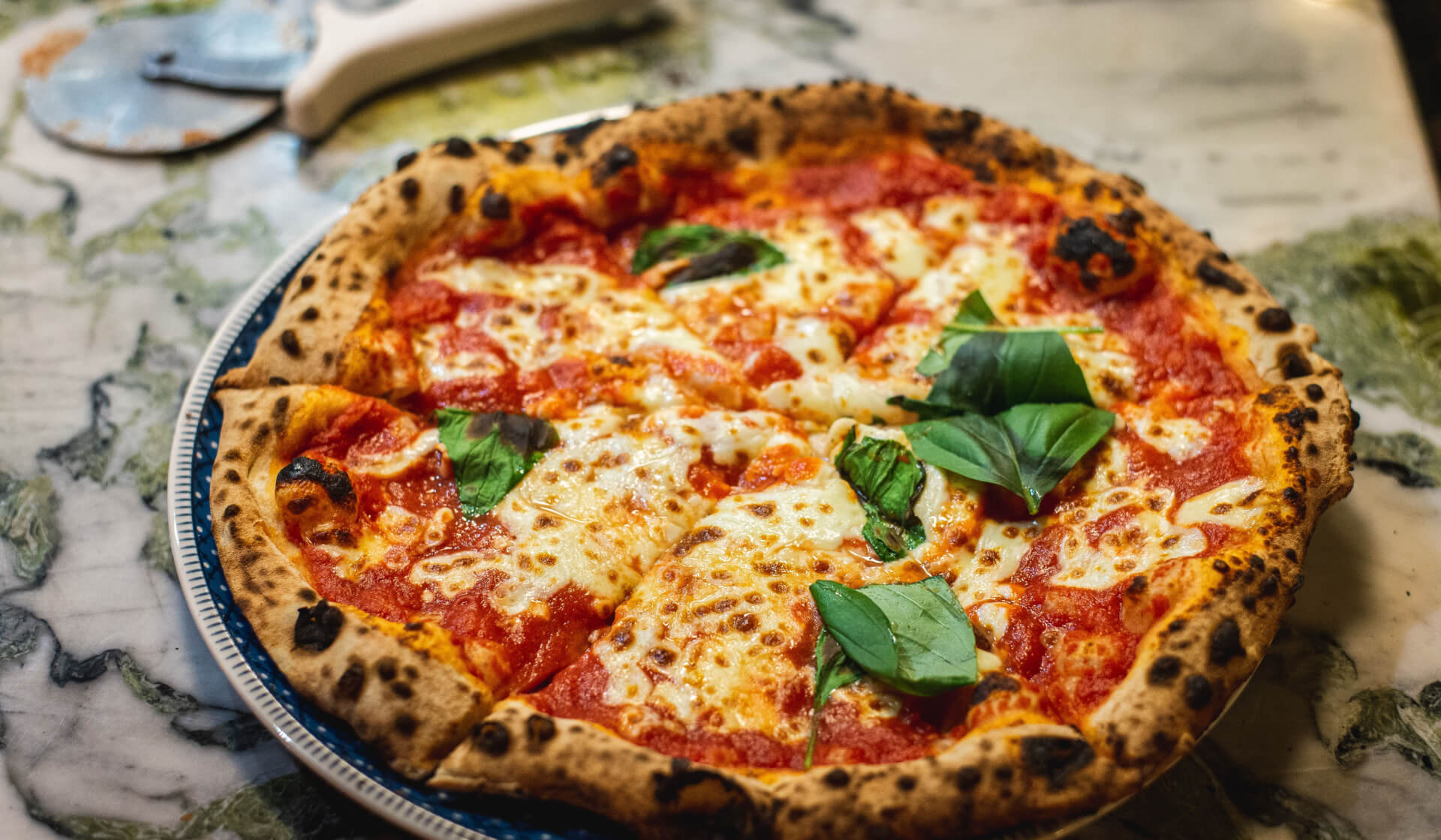Authentic Italian pizza from the 10 Best Food Dishes in the World, loaded with cheese and fresh toppings.