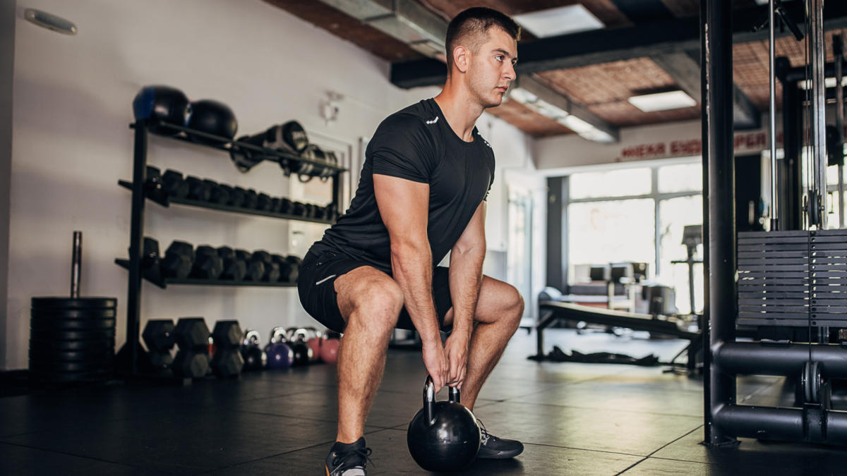 10 Top Fitness Trends in the World - Functional strength training with resistance bands and kettlebells in a gym.