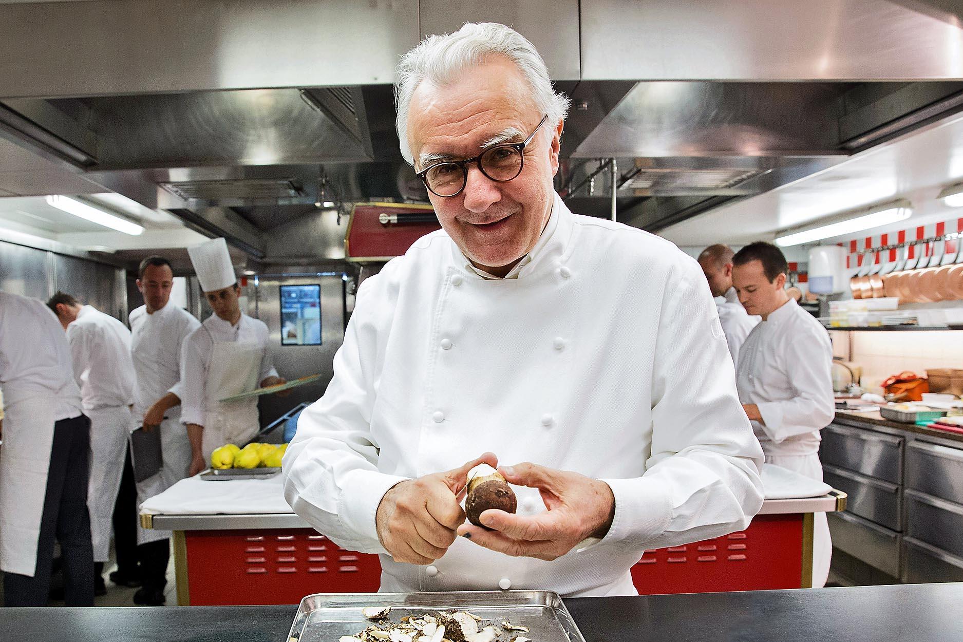 Alain Ducasse garnishing lobster with truffle jus – elite chef among the 10 Most Famous Chefs in the World with 21 Michelin stars.