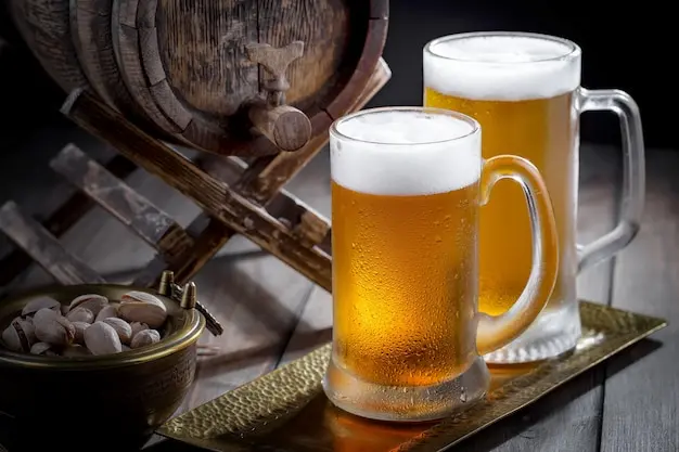 Cold glass of beer with foam showing beer’s cultural impact in the 10 Most Popular Beverages in the World.