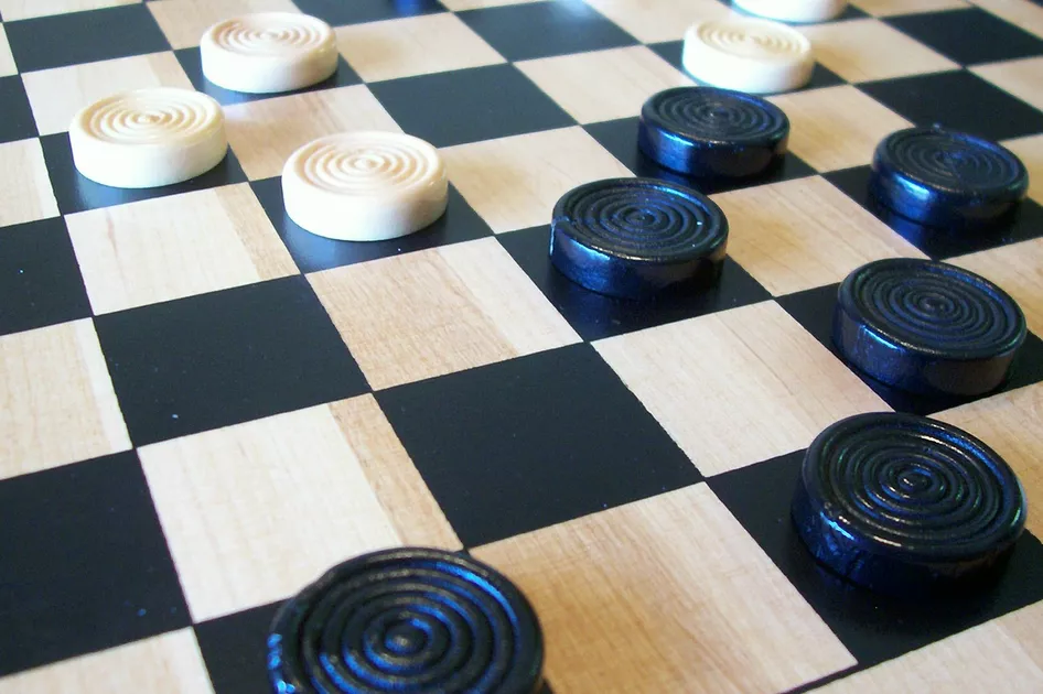 Checkers game board showcasing white and black pieces from the 10 Most Popular Board Games in the World list.