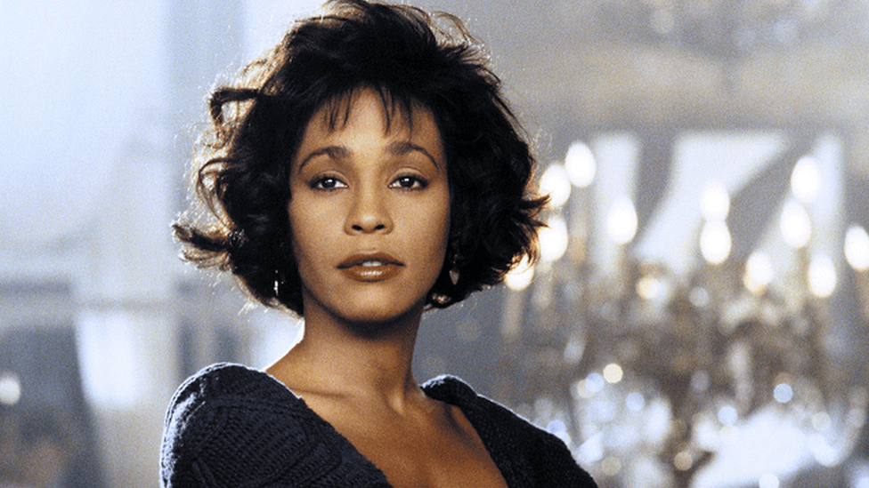 Whitney Houston belting I Will Always Love You, ranked among the 10 Most Popular Songs of All Time.