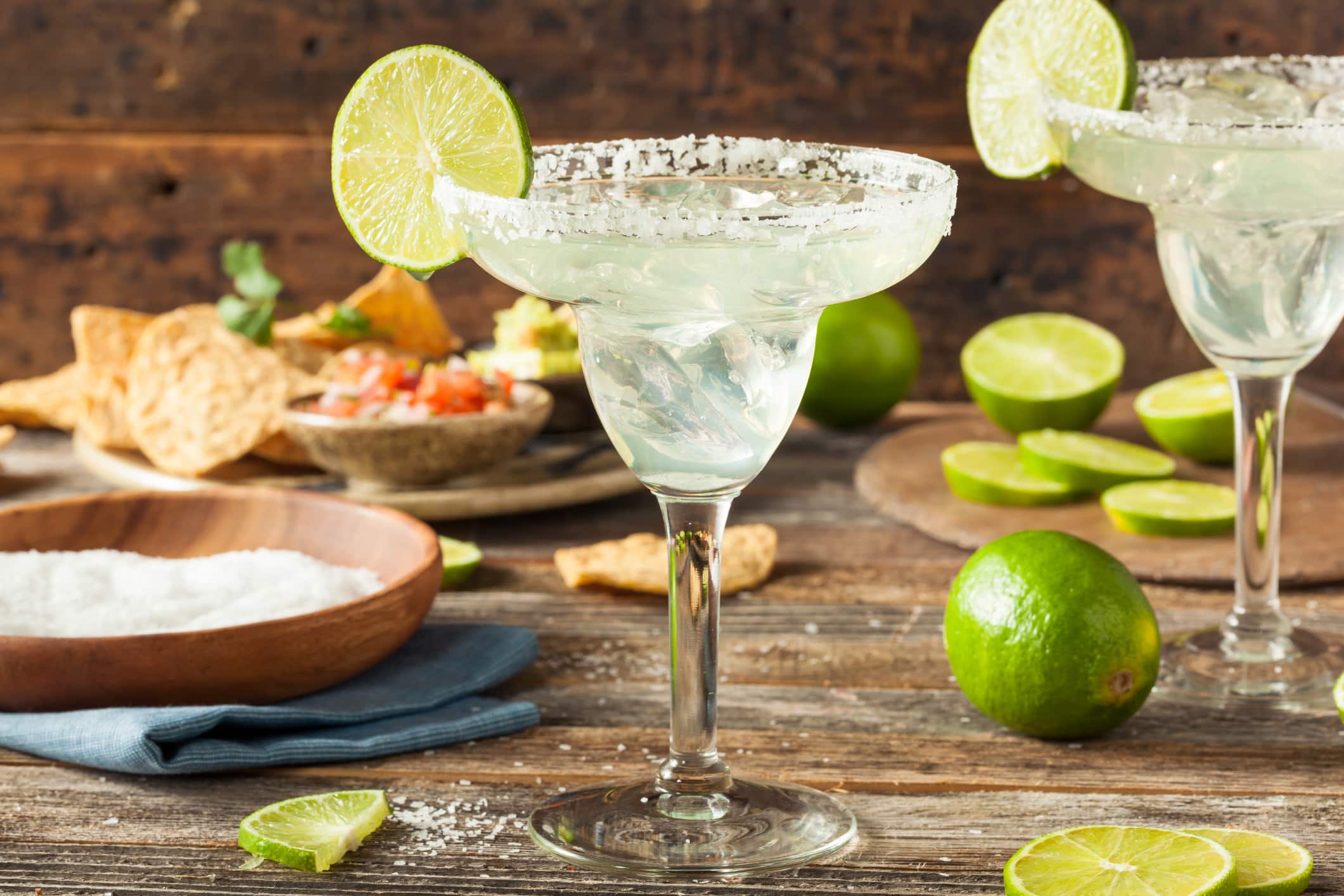 Margarita cocktail with salt rim and lime – one of the 10 Most Popular Cocktails in the World served in a classic margarita glass.