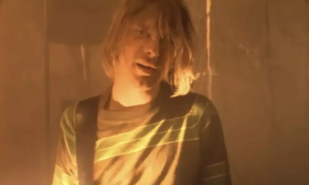 Nirvana's Kurt Cobain performing Smells Like Teen Spirit, listed in the 10 Most Popular Songs of All Time.