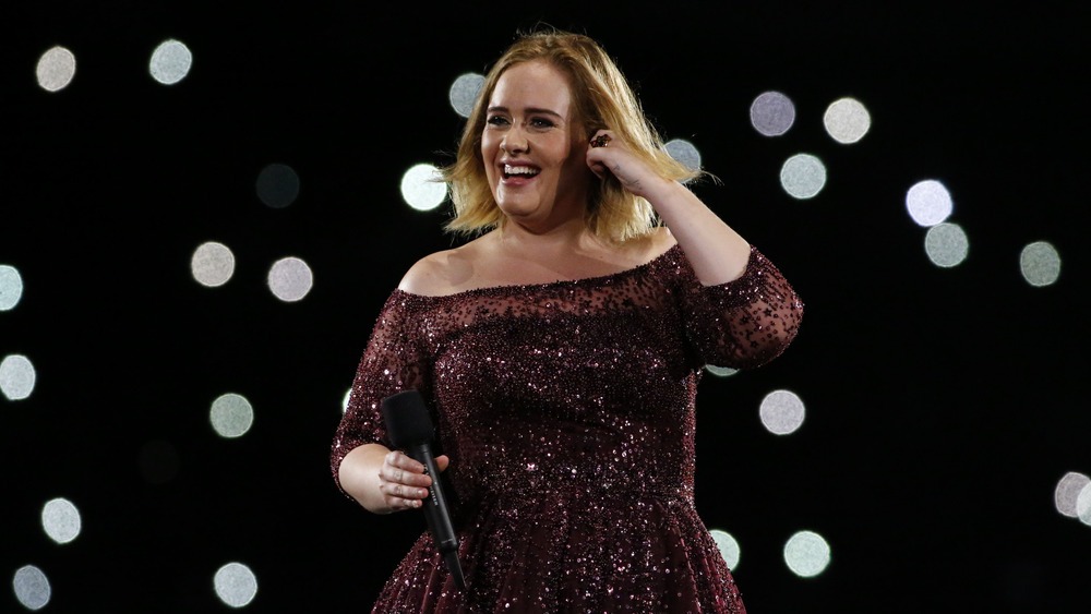 Adele on stage singing Rolling in the Deep, featured in the 10 Most Popular Songs of All Time.