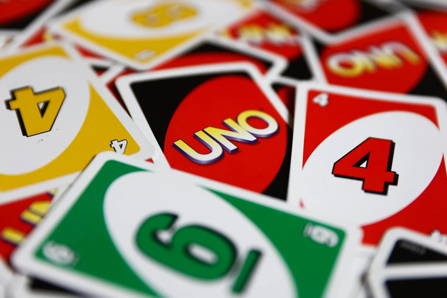 Uno card game action shot featuring wild and draw four cards from the 10 Most Popular Board Games in the World.