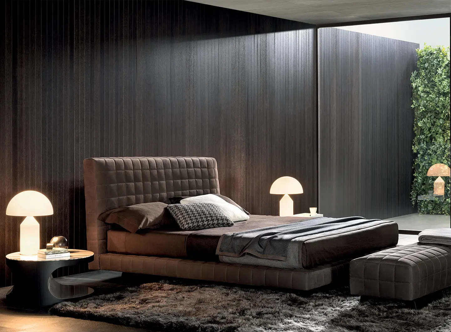 Velvet upholstered bed and wood nightstand from Complete Luxury Furniture Buying Guide for luxurious master bedrooms.