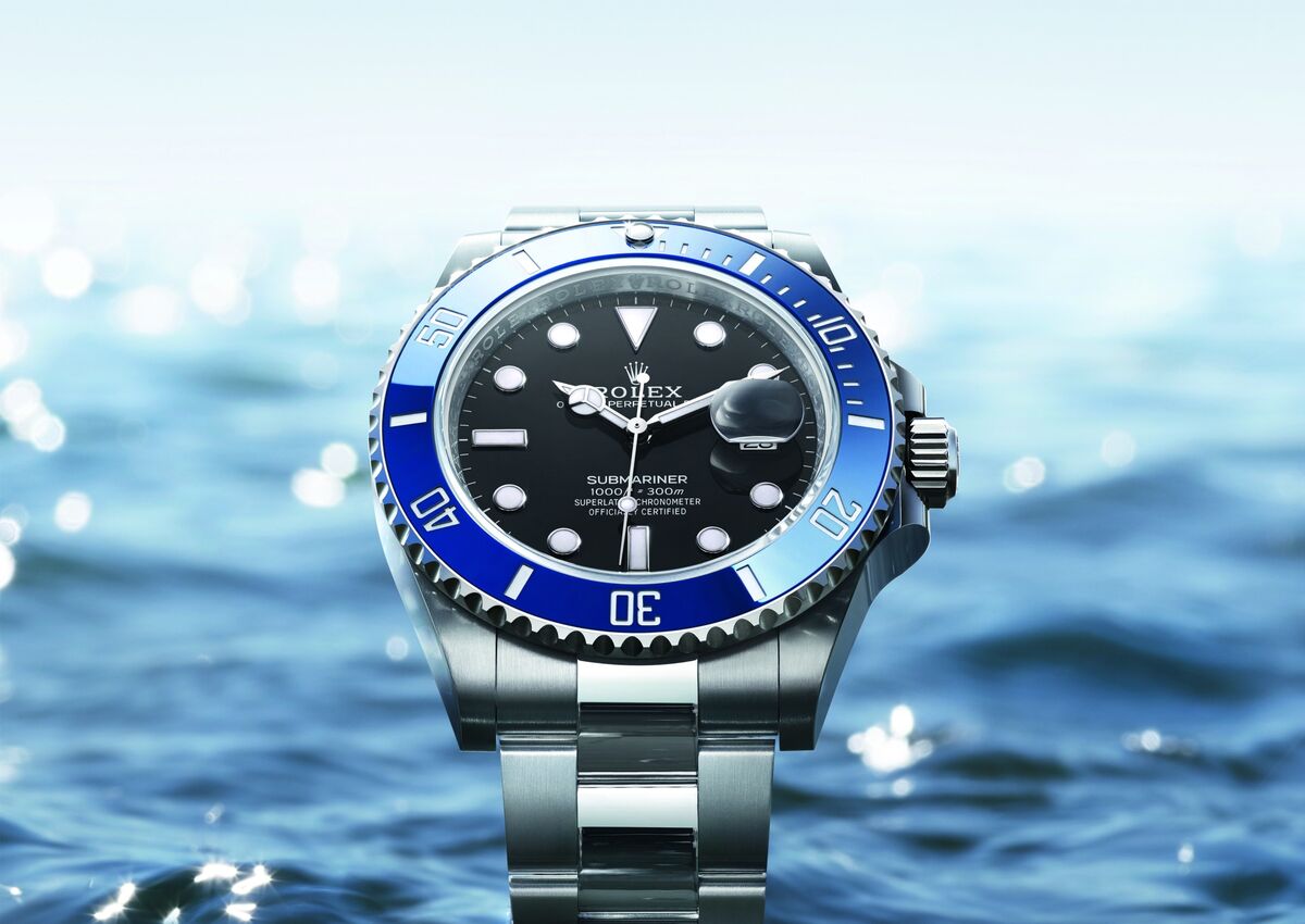 Ultimate Luxury Watch Buying Guide featuring Rolex Submariner with specs, price range, and iconic design details.