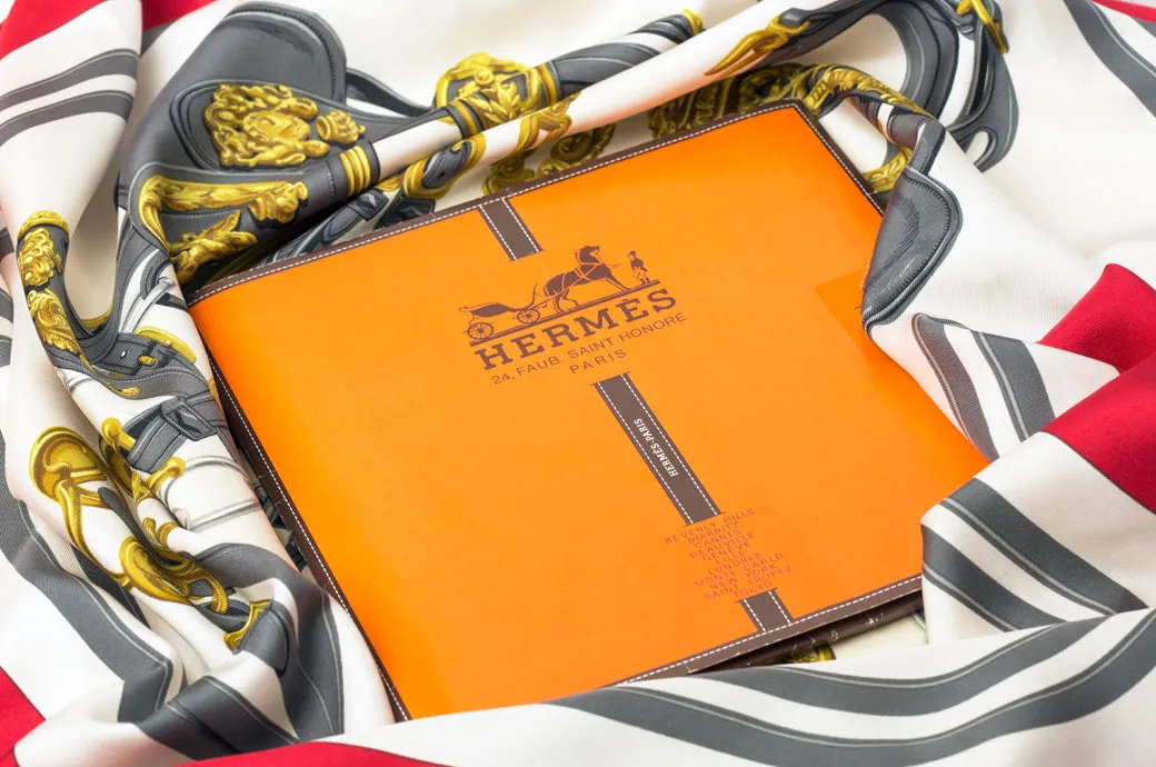 Hermes scarve and box showcasing artisan craftsmanship in the 10 Top Luxury Brands in the World.